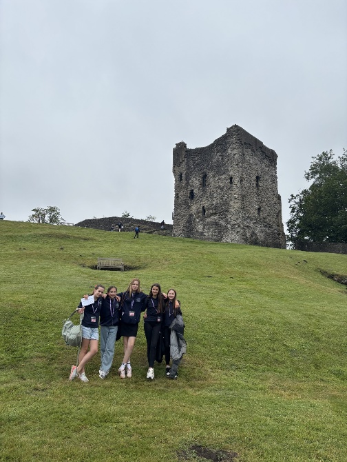 Students smiling in front of St Edmund's Church