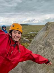 A student posing on Higger Torr