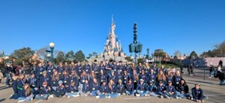 Hope Valley College Disney Choir in front of the Sleeping Beauty castle at Disneyland Paris