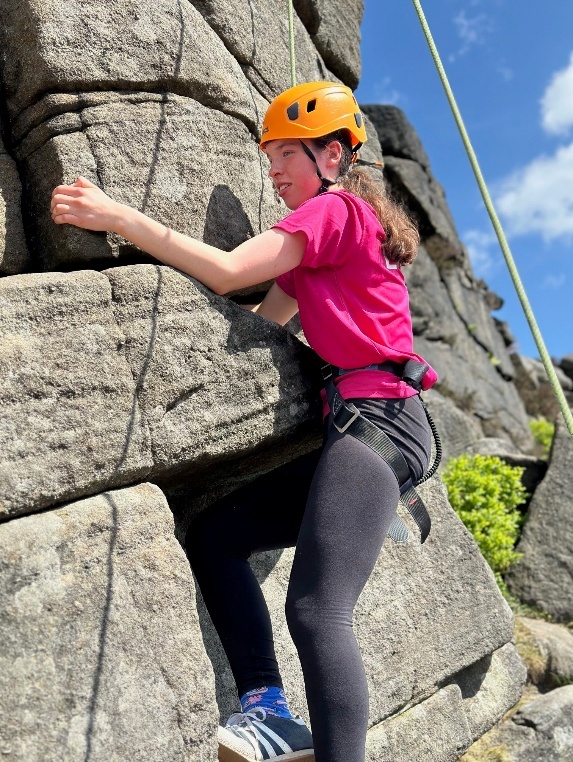 Year 9 student climbing a rock face in Burbage North